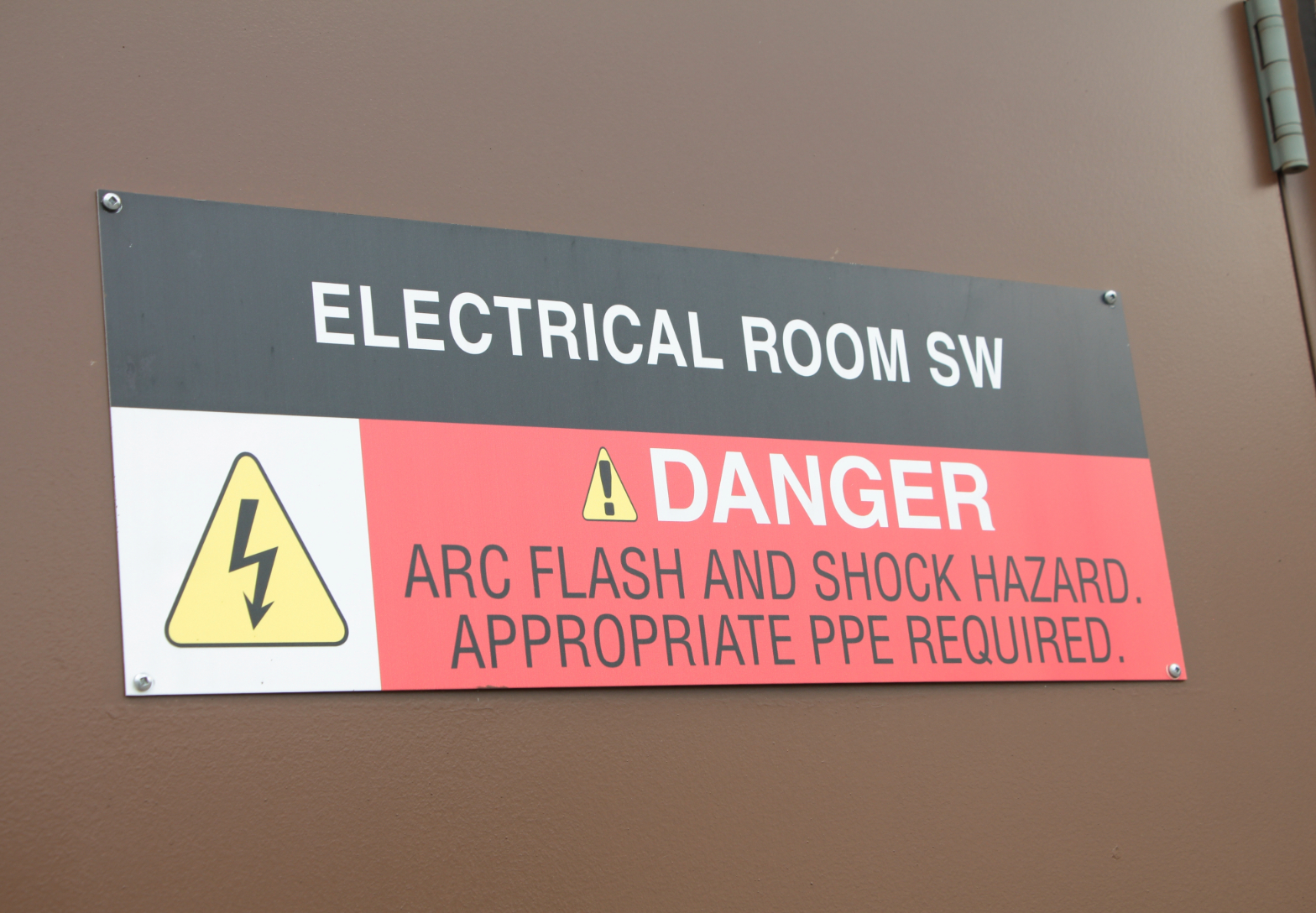  Electrical Room SW Sign with a Danger Message: Arc Flash and Shock Hazard. Appropriate PPE required.