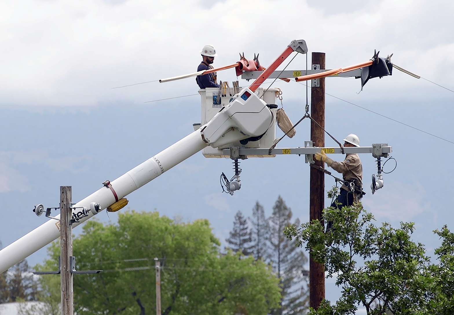 Lineman inspecting transmission line
