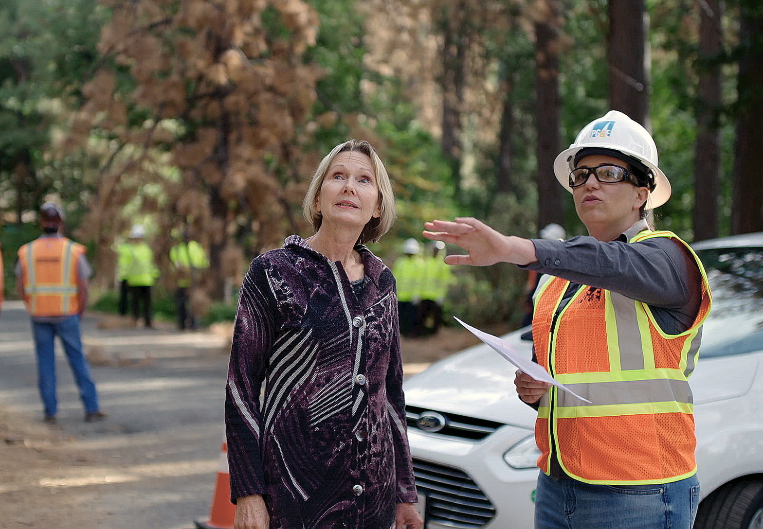 PG&E worker and person looking at vegetation management work