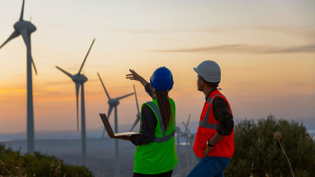 Two PG&E employees inspecting windmills