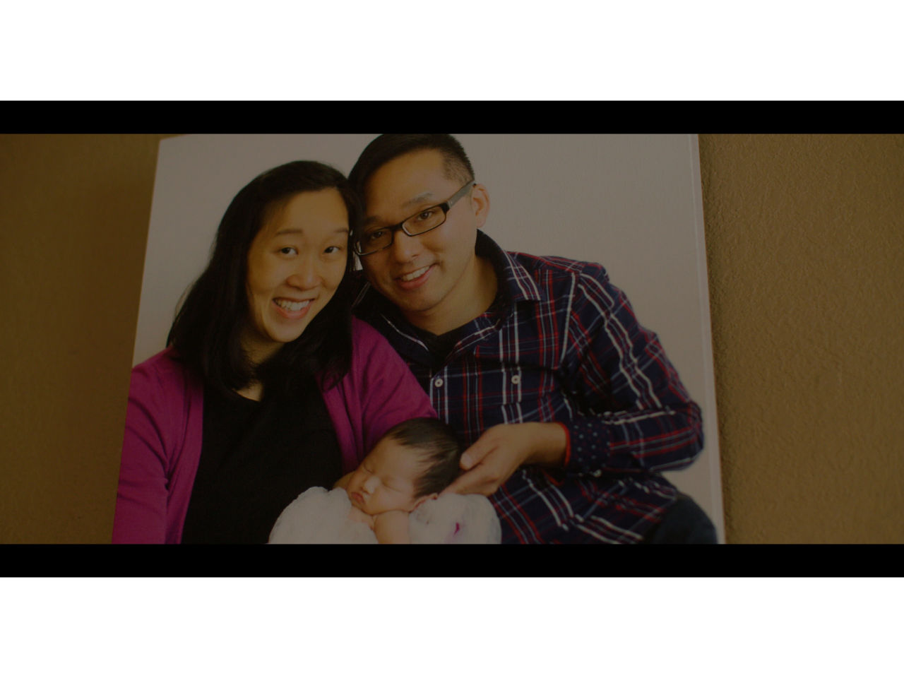Olivia as a baby with her parents