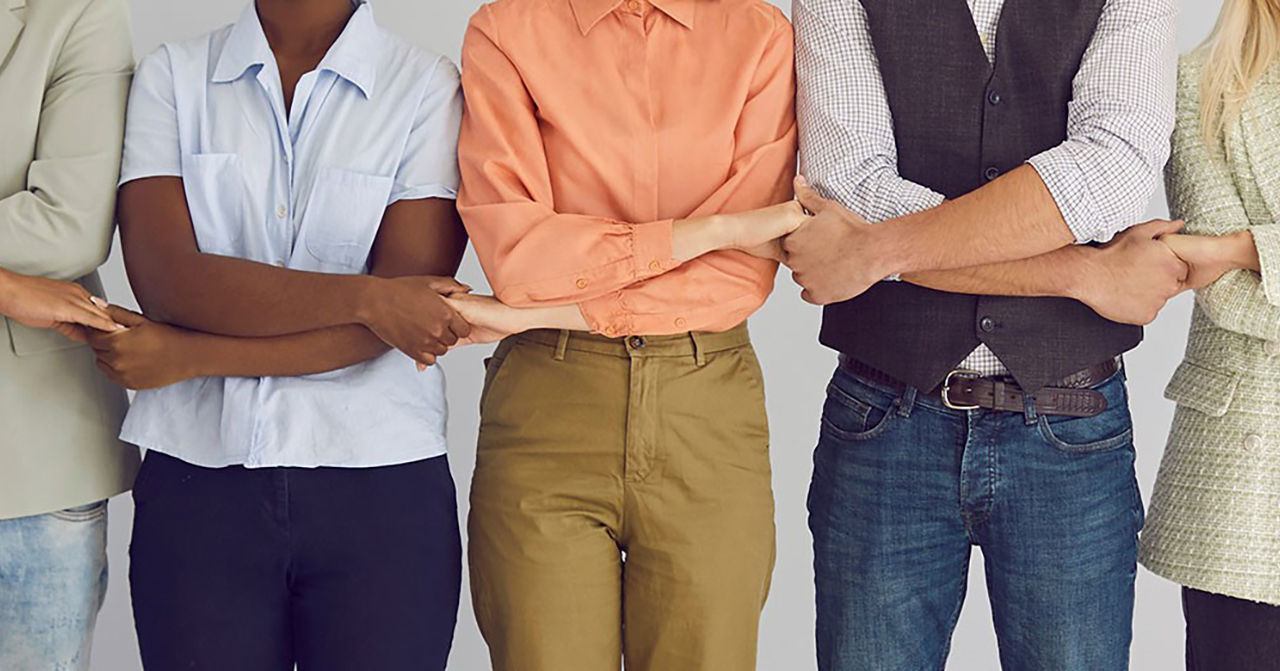 people standing next to eachother holding hands