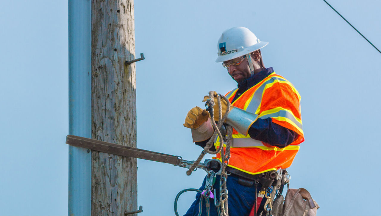 PG&E crew member working on power tower/poll