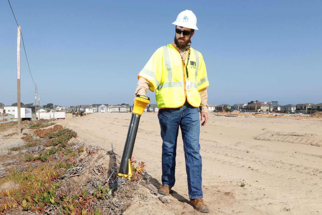 PG&E crewmember using utility locator tool